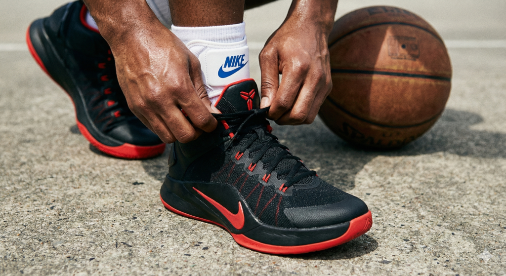 Close up of youth basketball gear including shoes and ankle braces for injury prevention.